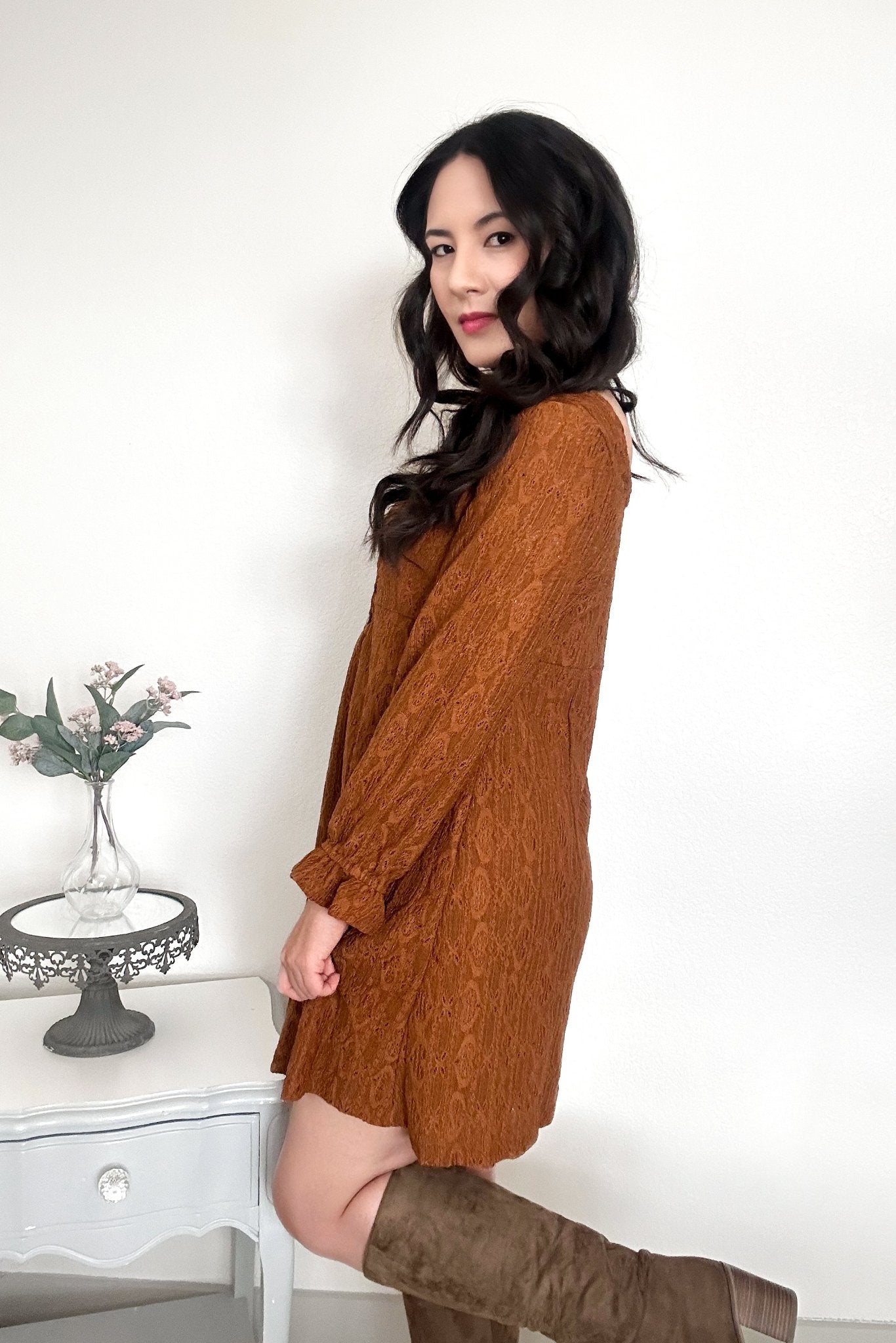 Side view of woman wearing a chestnut-colored mini dress