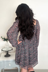 Back view of woman wearing a green floral mini dress