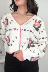 Woman wearing a vintage inspired pink floral cardigan